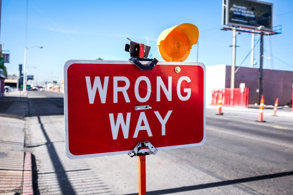 Wrong way road sign representing common website hosting mistakes to avoid
