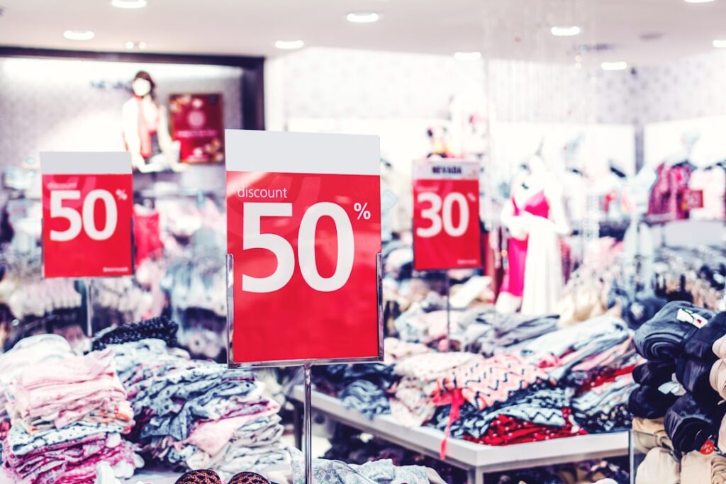 Red 50% discount signs in a retail store representing hosting deals and savings opportunities
