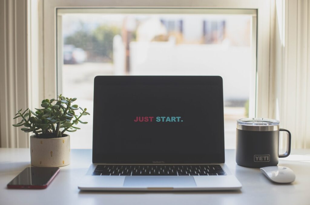 Laptop displaying 'JUST START' message representing getting started with web hosting