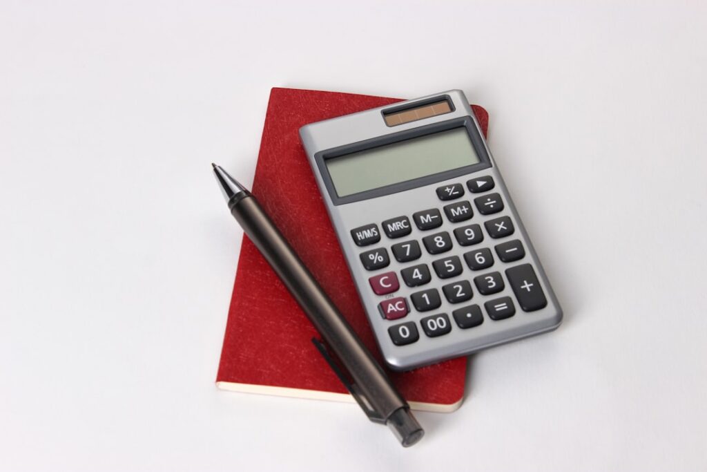 Calculator and pen on notebook for budget planning and cost comparison