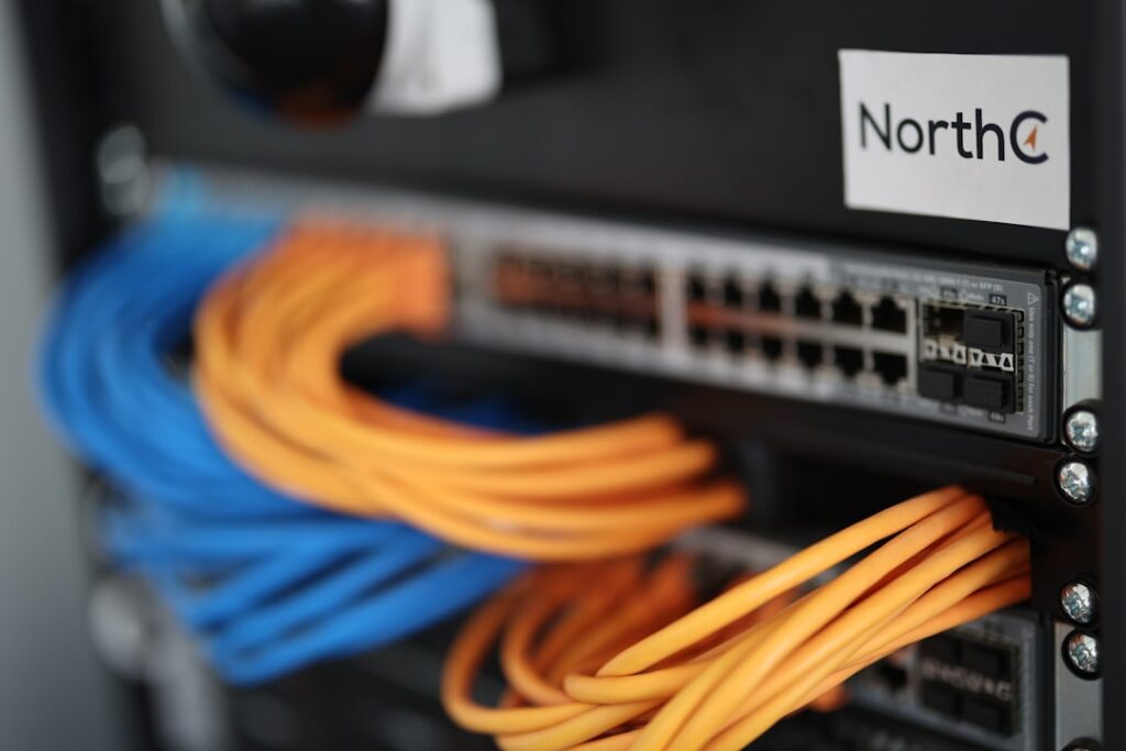 Network patch panel with ethernet cables showing DNS and hosting connection infrastructure