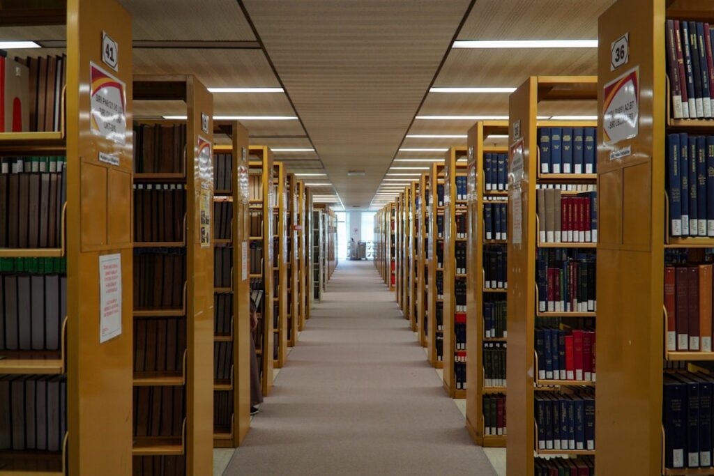 Academic library with rows of bookshelves filled with research materials