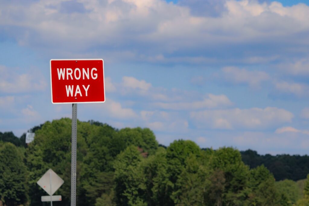 Wrong way sign representing common mistakes to avoid with free hosting