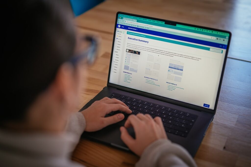 Person working on laptop computer making decisions about website hosting options