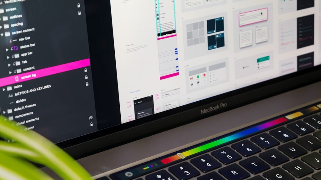MacBook laptop showing Google Material design interface for website development and design