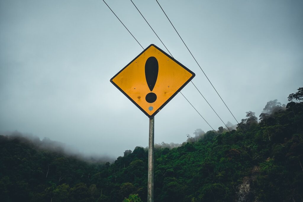 Warning sign with exclamation point representing common hosting mistakes to avoid