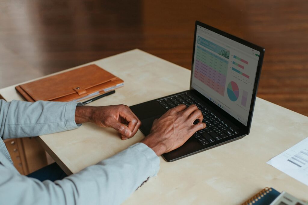 Person working on laptop with productivity charts and analytics visible, demonstrating business efficiency