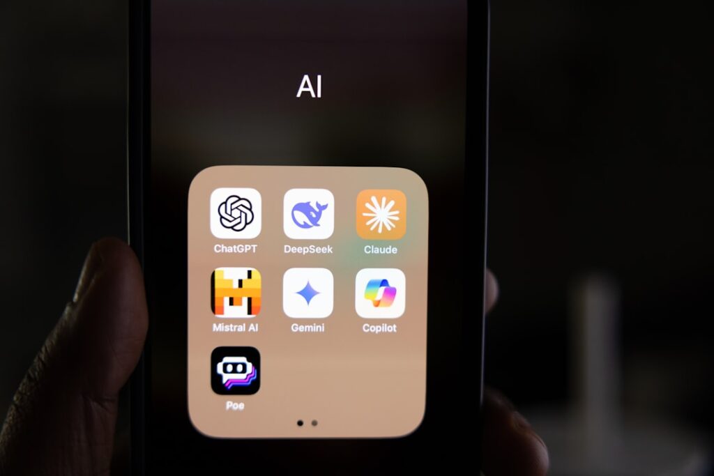 Smartphone displaying AI app icons on screen representing the best AI apps of 2026. Photo by changing landscapes in LLM on Unsplash