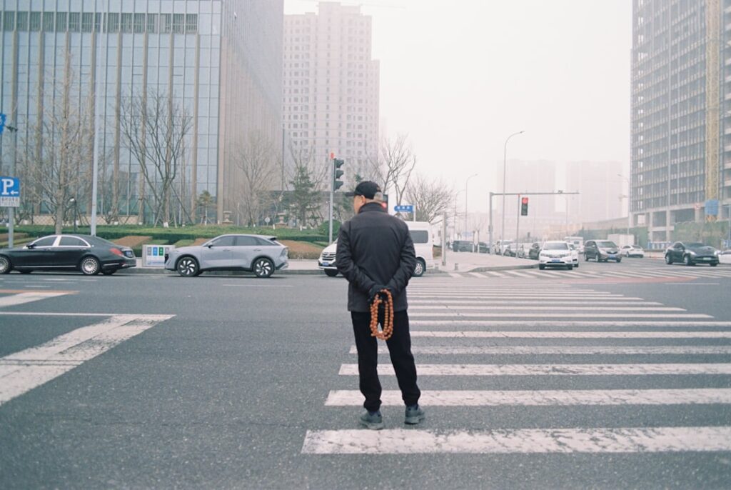 Business person at crosswalk making decisions representing hosting choice selection process