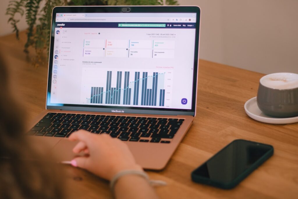 Person reviewing analytics charts on laptop screen for comparing AI app performance and features