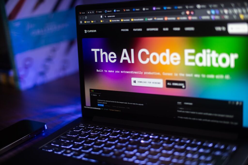 AI code editor interface displayed on laptop screen showing artificial intelligence website development tools by Cursor AI