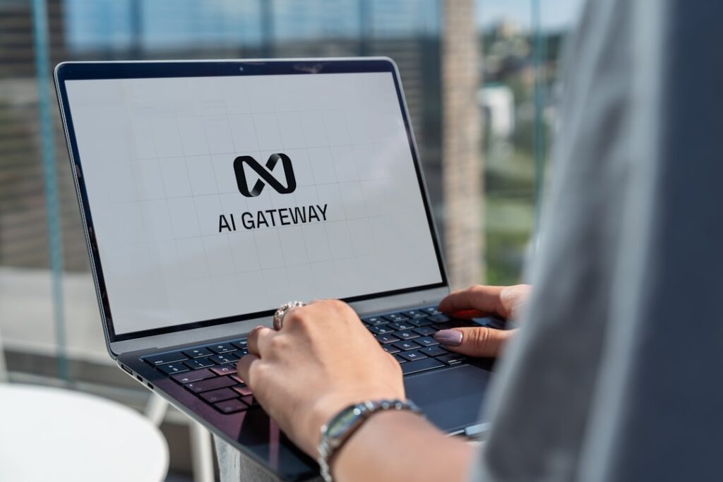 Person working on laptop computer with AI gateway interface displayed, representing productivity AI tools and applications