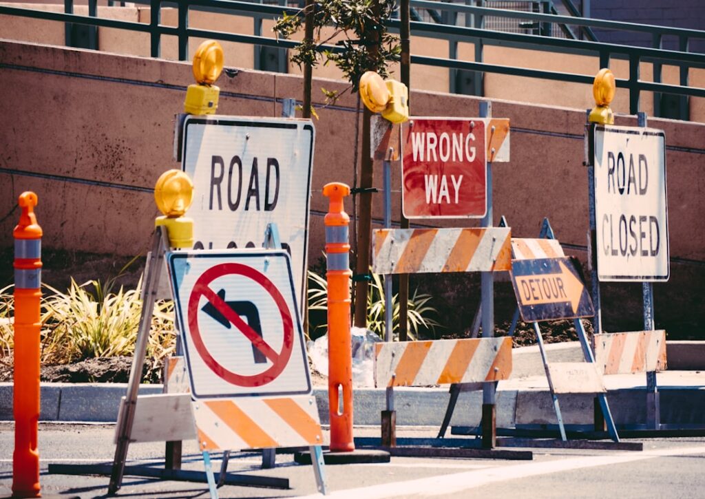 Warning signs and construction barriers representing common WordPress mistakes to avoid