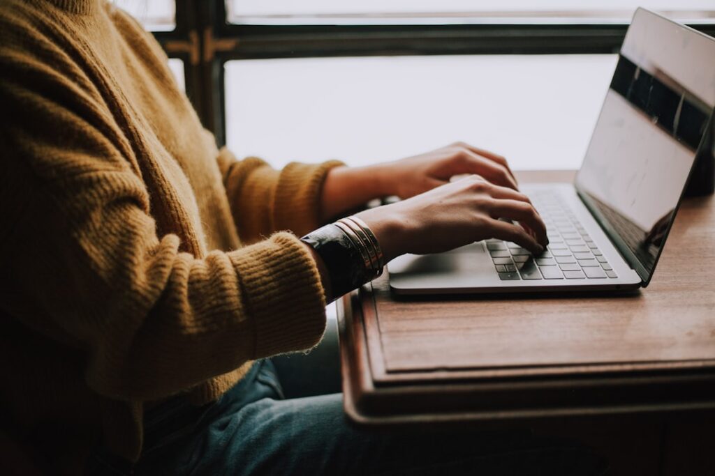 Person working on laptop building a website - Photo by Glenn Carstens-Peters on Unsplash