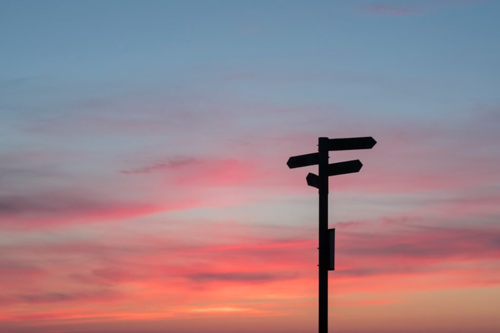 Directional signpost at crossroads representing the choice between WordPress.com and WordPress.org