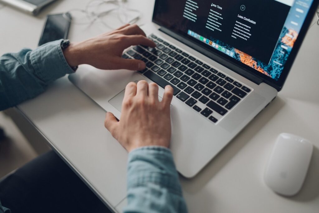Person typing on laptop for content creation and blogging workflows