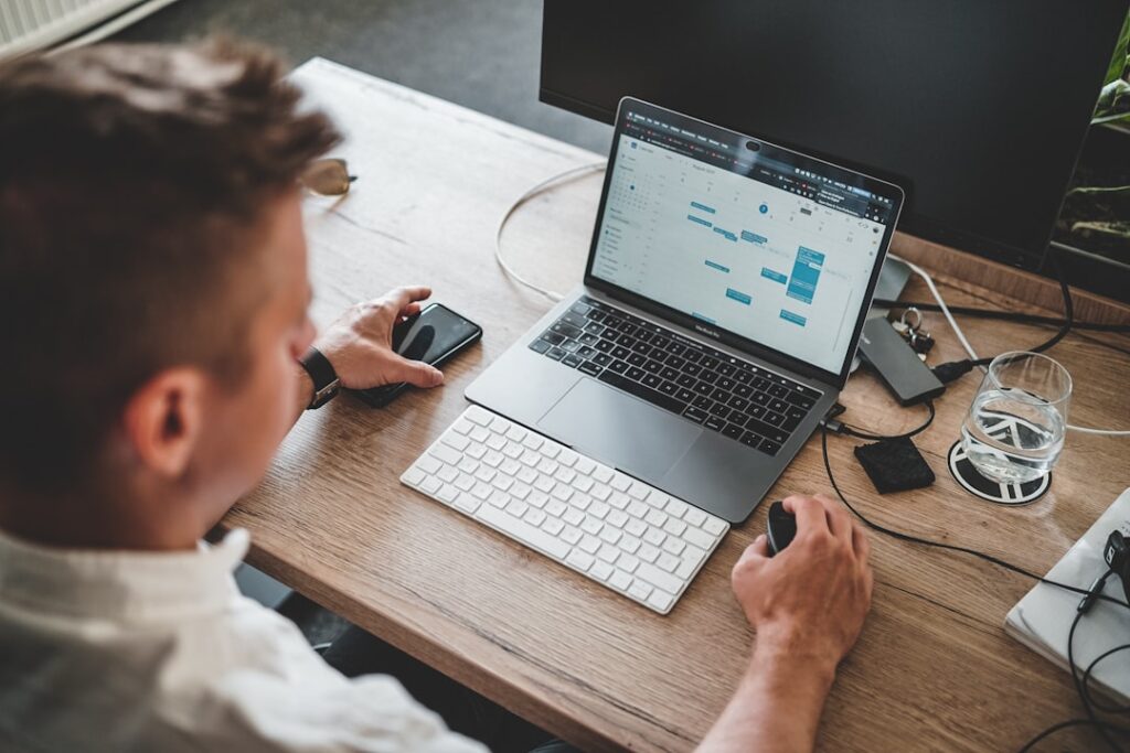 Person working on laptop with data analysis charts showing AI productivity apps in action