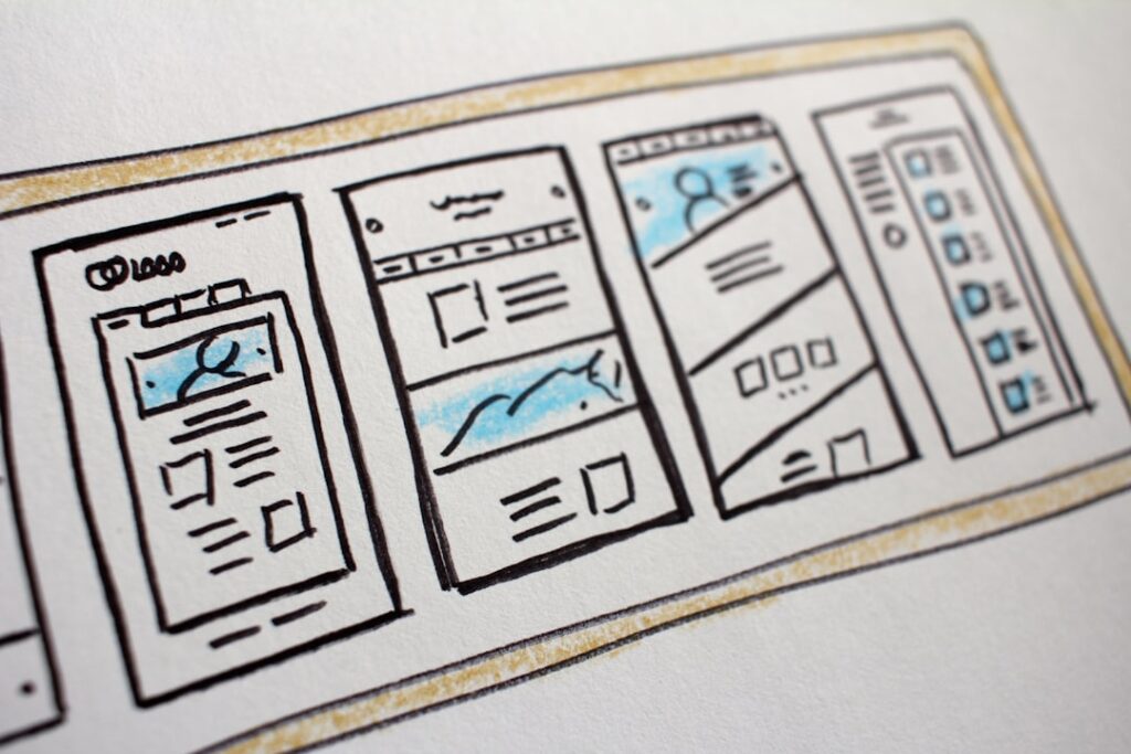 Hand-drawn website wireframe sketches showing basic page layouts and navigation elements