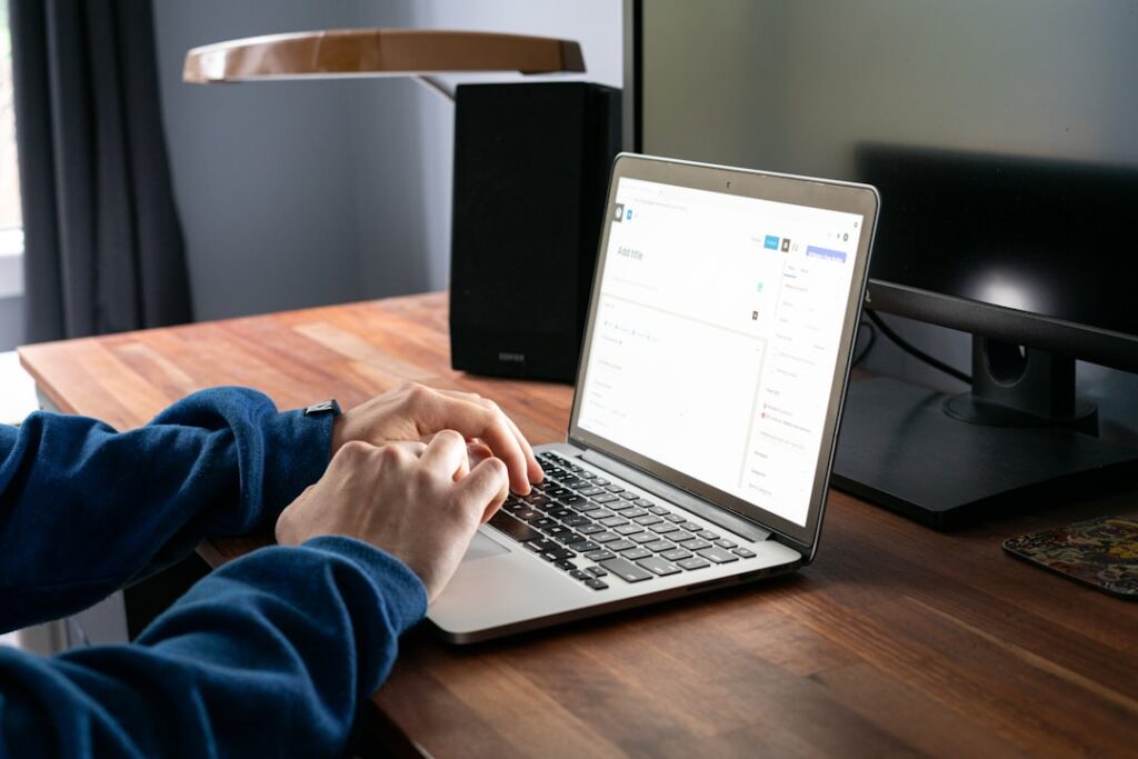 Person typing a new WordPress post on a MacBook - Photo by Lucas Hoang on Unsplash