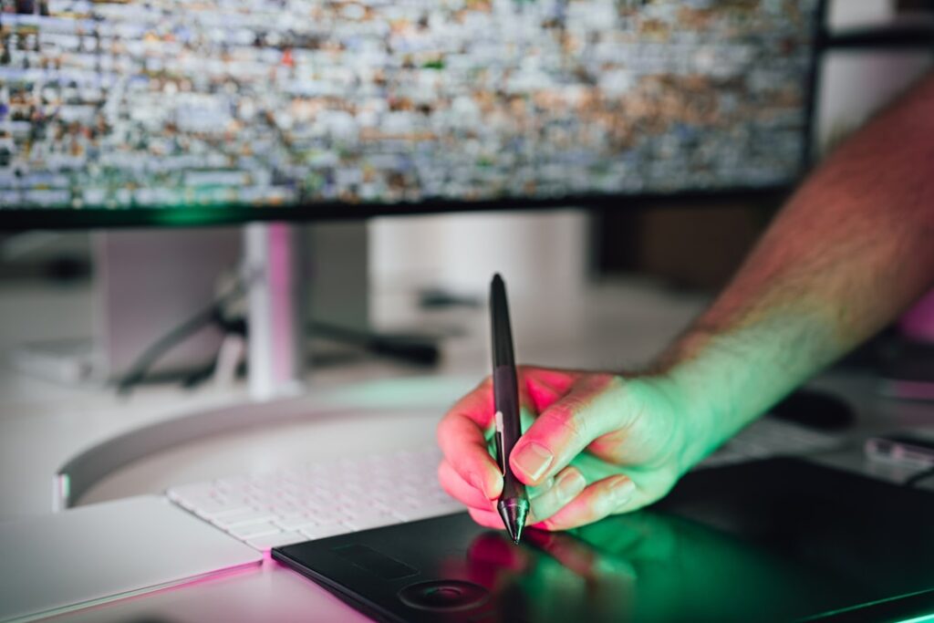 Designer using graphic tablet for digital design work with AI design tools