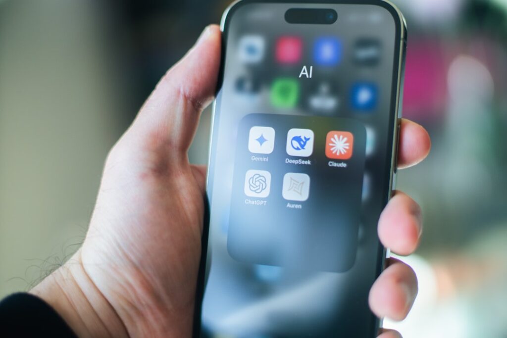 Mobile phone showing AI apps including ChatGPT and other artificial intelligence applications on home screen