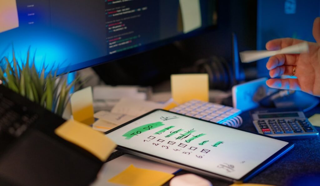 Digital tablet displaying task management checklist in a modern workspace with productivity tools