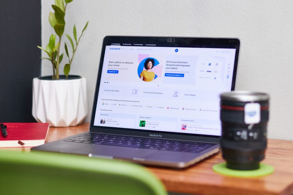 Modern workspace with laptop showing website dashboard, plant, and coffee mug - Photo by Unsplash