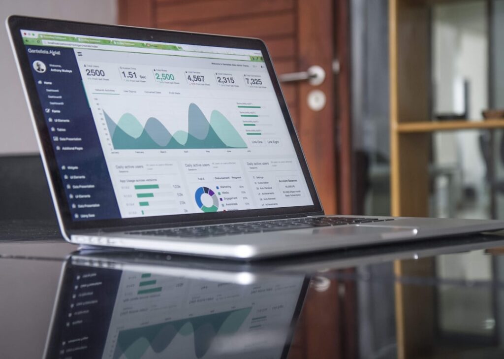 Analytics dashboard on laptop showing pricing data charts and statistics - Photo by Lukas Blazek