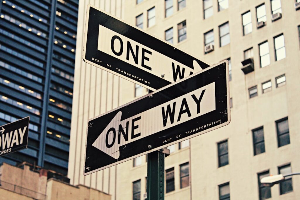 One way street signs pointing in different directions representing decision making