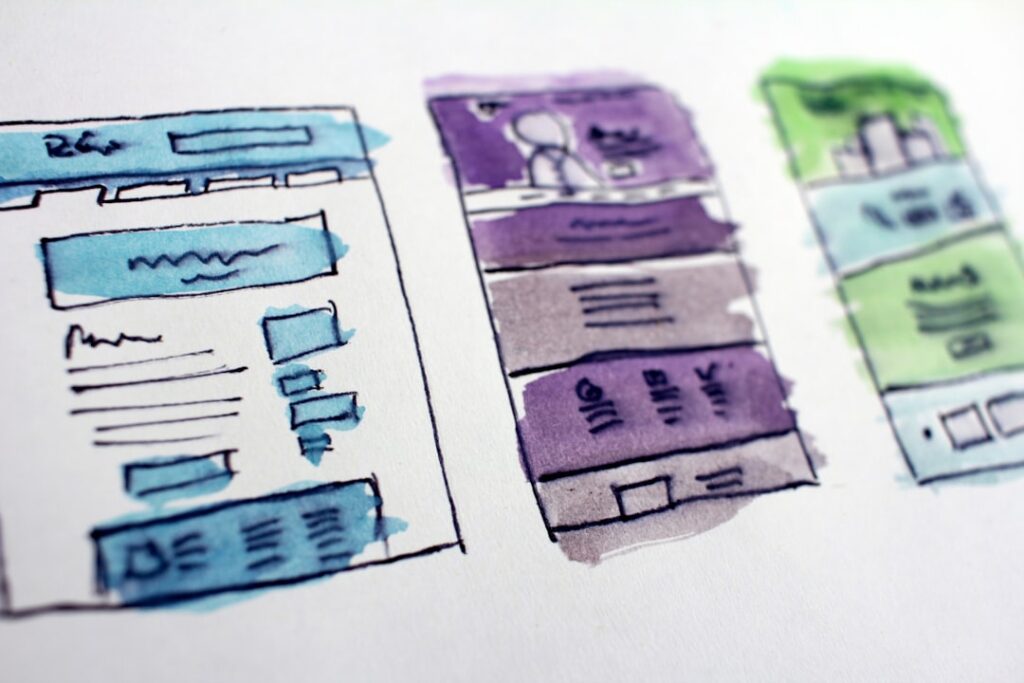 Watercolor wireframe sketches of website layouts representing page builder design planning