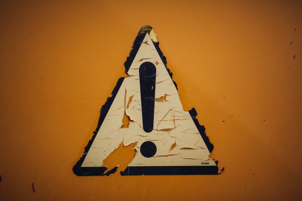 Weathered caution warning sign indicating common pitfalls to avoid