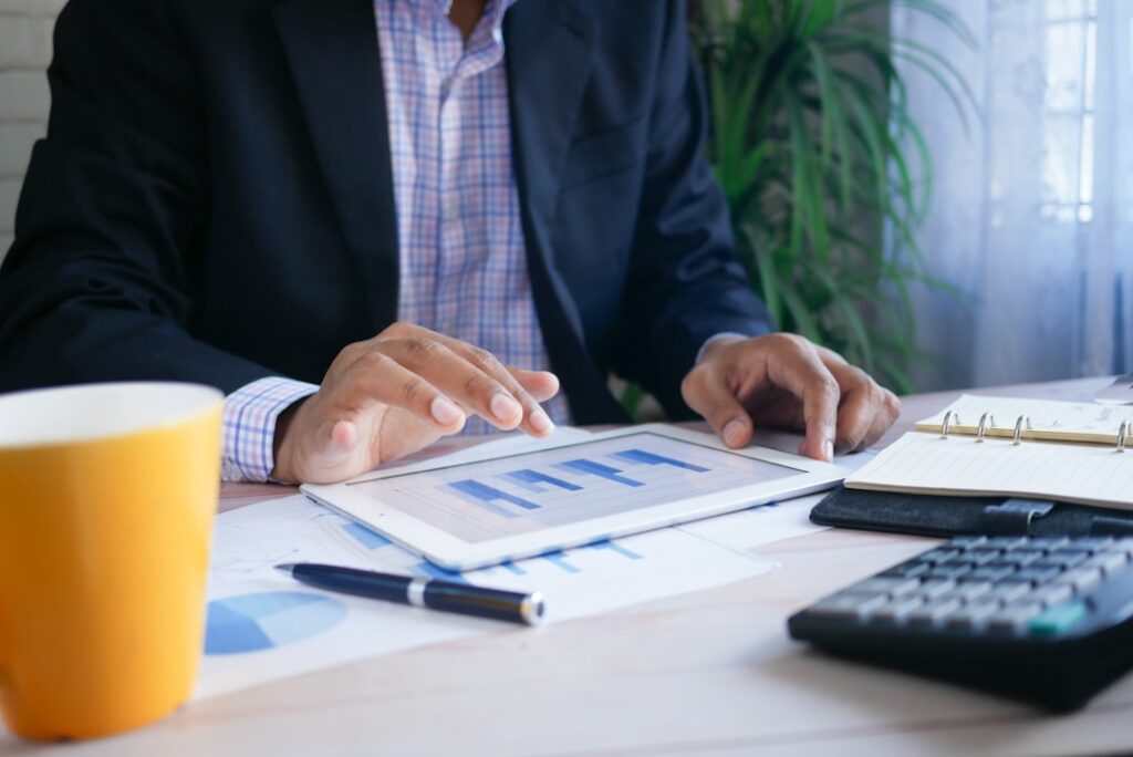 Business person analyzing budget and financial charts to make informed hosting decisions