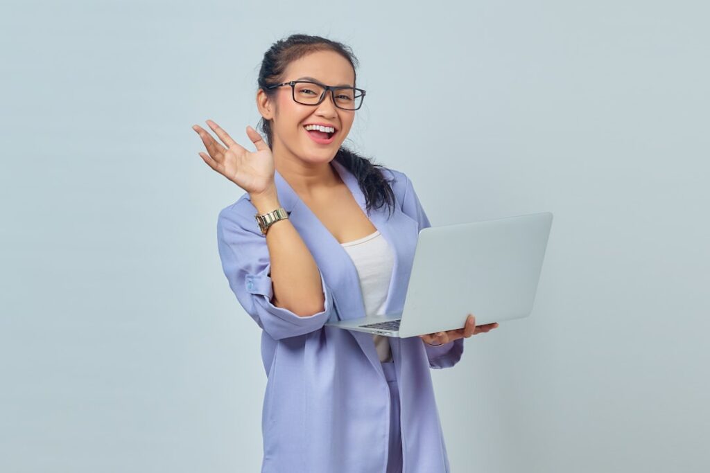 Confident business woman celebrating successful hosting decision with laptop