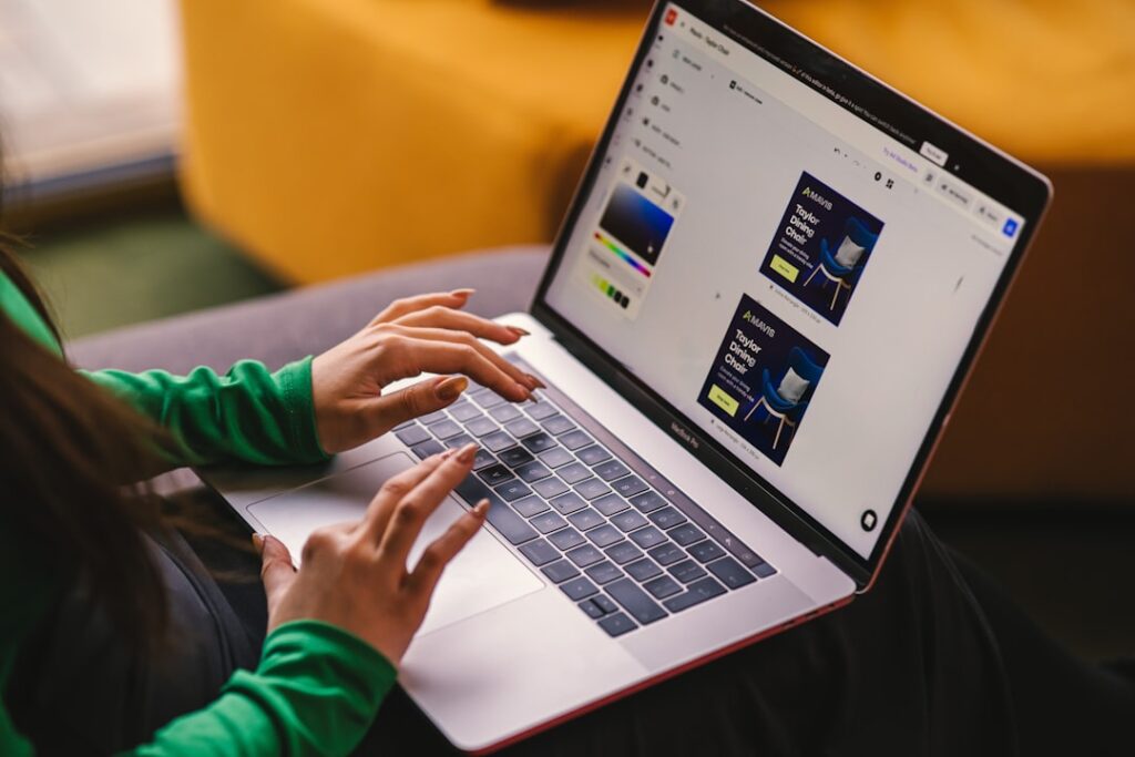 Person using a visual drag-and-drop web design interface on a laptop, representing Elementor WordPress page builder