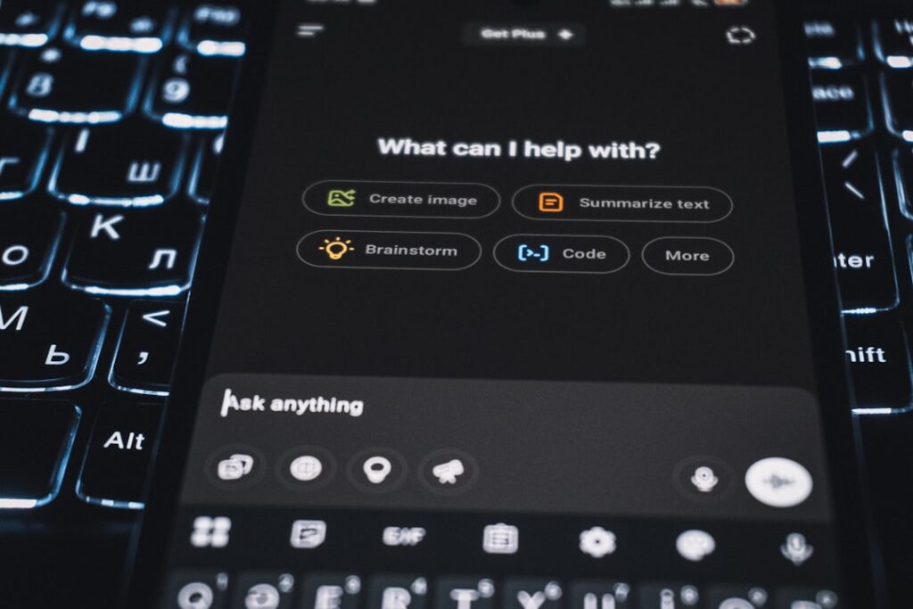 ChatGPT AI interface displayed on a smartphone screen resting on a keyboard, showing AI chatbot capabilities