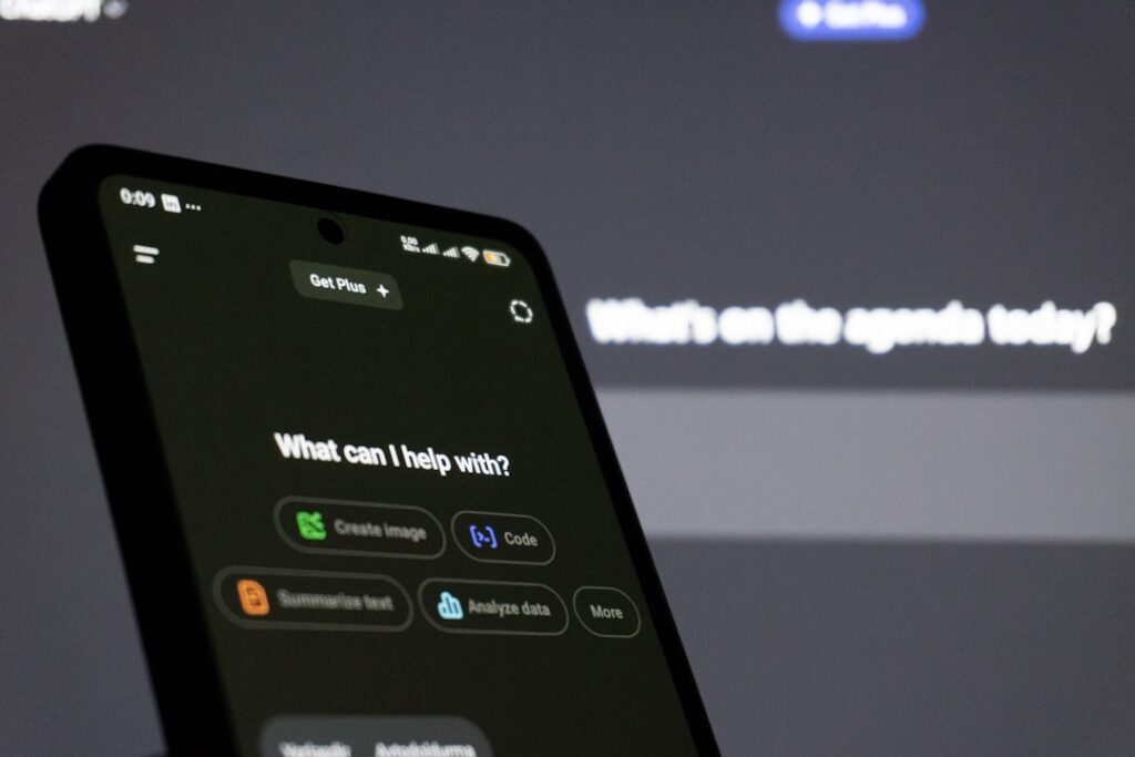 Smartphone screen displaying an AI assistant interface with options to create image, write code, summarize text, and analyze data
