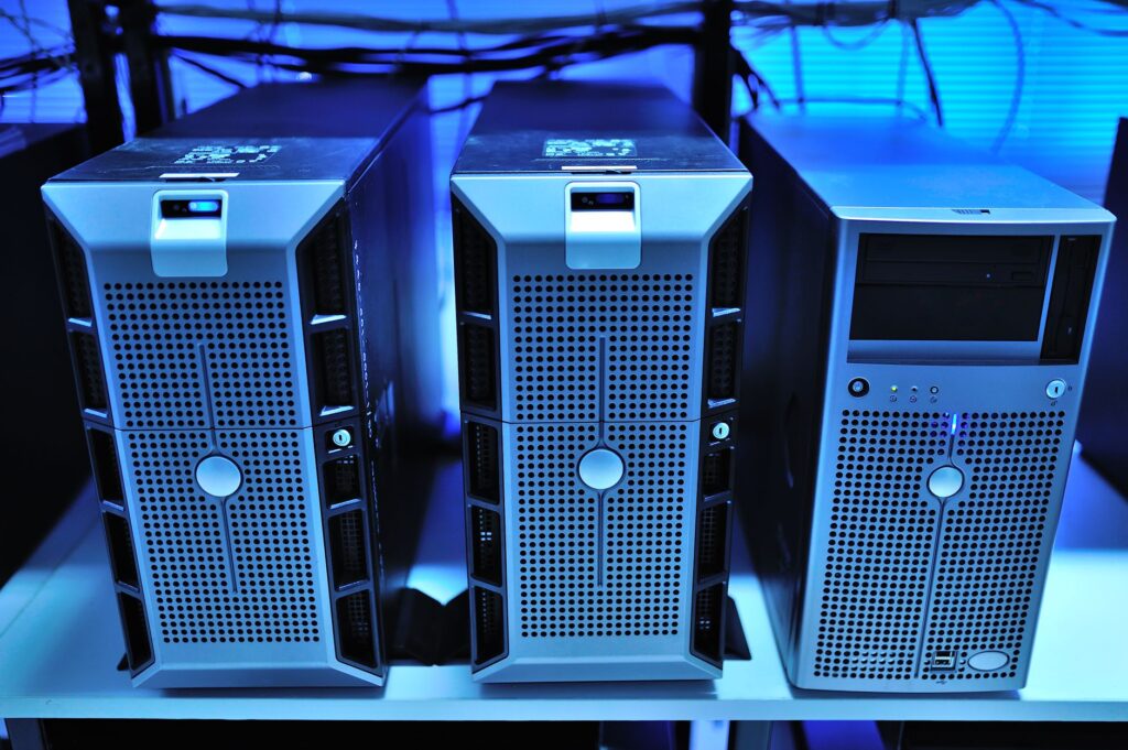 Server towers in a blue-lit data center representing web hosting infrastructure