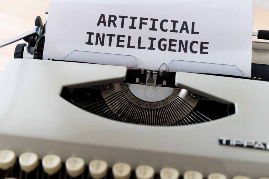 Vintage typewriter with a page reading Artificial Intelligence, representing AI-assisted writing tools