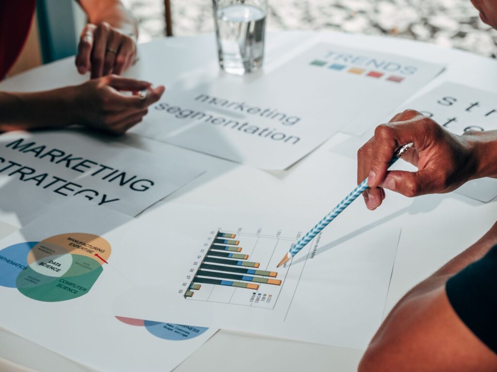 Team reviewing marketing segmentation charts and strategy documents on a desk