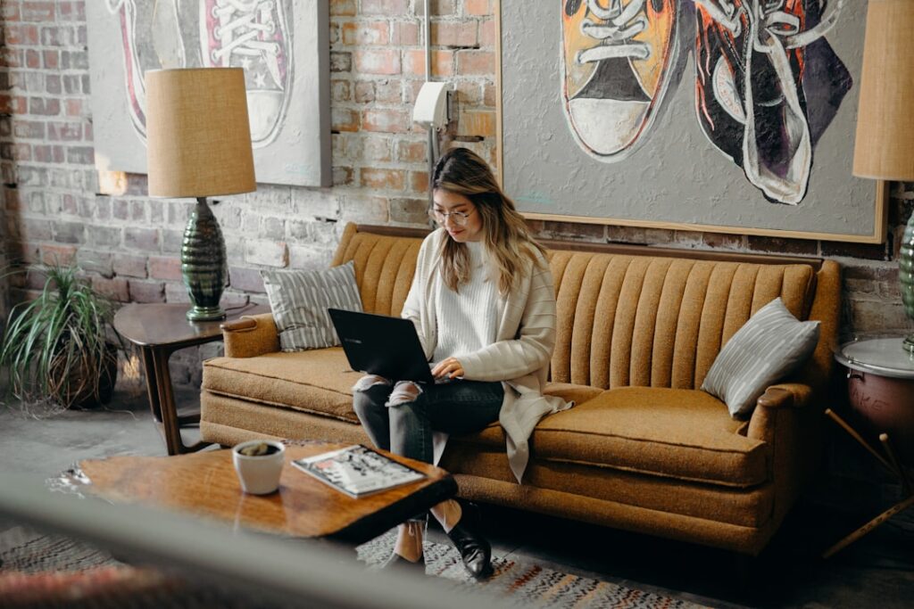 Small business owner working on a laptop, evaluating web hosting options for their website.