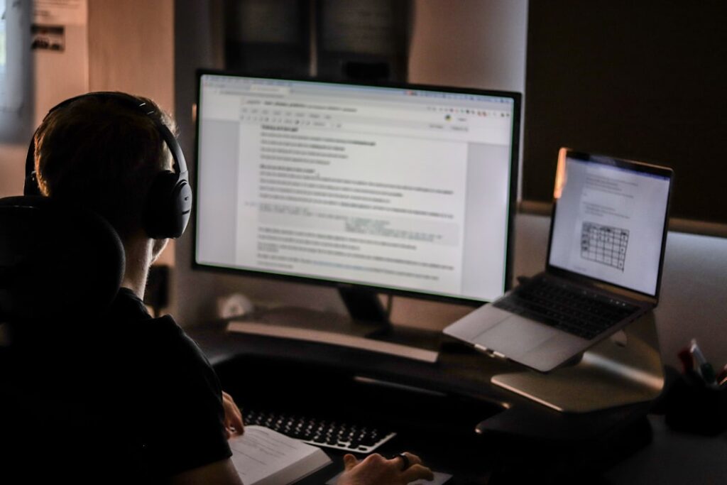Person reviewing text documents on a large computer monitor, representing the human annotation process behind AI training.