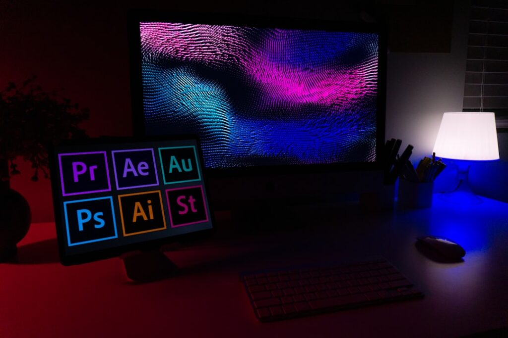 Design workstation showing Adobe creative suite tools including Photoshop, Illustrator, Premiere and After Effects, representing AI design tools for visual content creation.