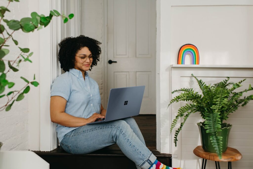 Woman sitting comfortably at home working on a laptop, representing a beginner getting started with WordPress
